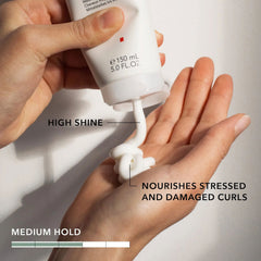 Goldwell StyleSign defining cream dispensing into hands from nozzle