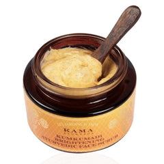 Face scrub jar with wooden scoop and pale cream paste