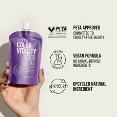 Purple hair gloss treatment bottle held in hand with white screw cap