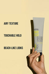 Hair styling creme tube held in hand, KMS HairPlay beach style, 100 ml