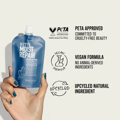 Hand holding KMS Moist Repair hair treatment pouch, blue, 100 ml, flip-top cap.