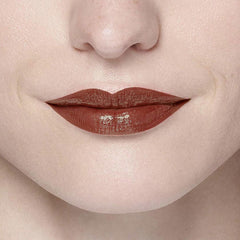 Brown-red glossy lips with light sparkle, close-up of mouth.