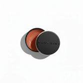 nude kiwi moisture lock lip balm jar, open black lid with nude-brown balm inside