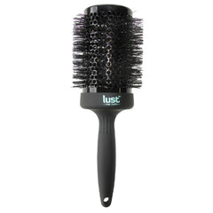Ceramic hair brush with round black brush head, black bristles, and Lust handle label