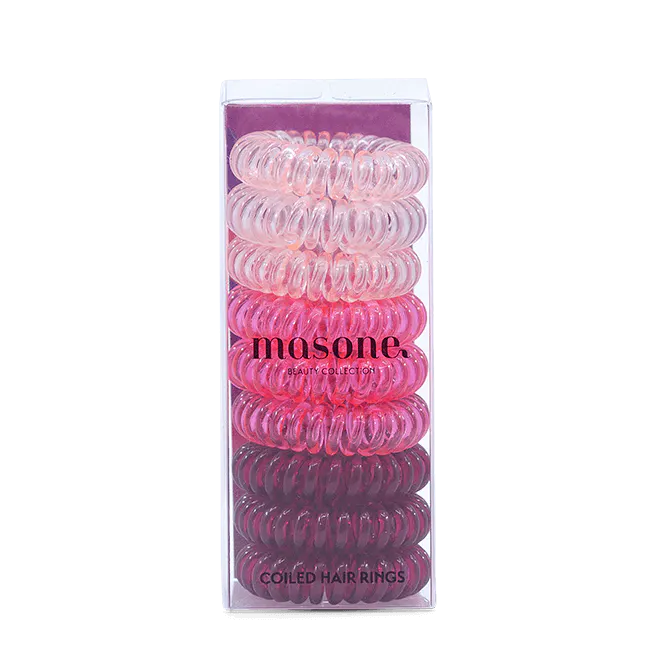 Pink coiled hair rings in clear box packaging