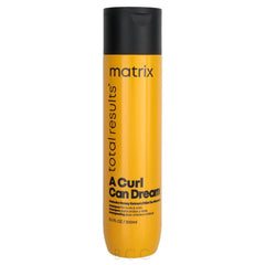 Orange shampoo bottle with black cap, Matrix Total Results and A Curl Can Dream label