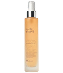 Milk_shake integrity incredible oil 50 ml pump spray bottle with amber-gold liquid.