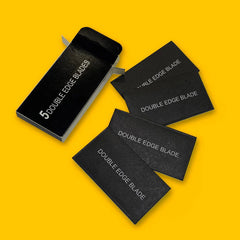 Double-edge razor blade refill pack with five blades, black packaging and blade wrappers