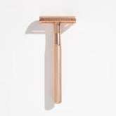 Gold safety razor with textured handle and twin-blade head