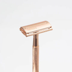 Gold safety razor with twin-blade head and MINIM engraving on cover