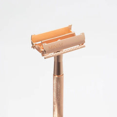 Gold safety razor with open twin-blade head and textured grip handle