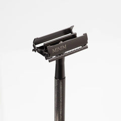 Gunmetal safety razor with angled open comb head and textured grip handle
