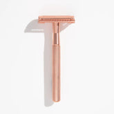 Rose-gold safety razor with textured handle and open double-edge head