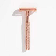 Rose-gold safety razor with textured handle and open double-edge head