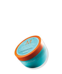Moroccanoil restorative hair mask jar with orange cap and teal container