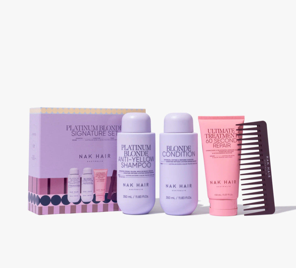Platinum blonde hair care trio pack with shampoo and conditioner bottles, plus brush