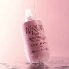 Pink detangle mist bottle with spray head and water splash