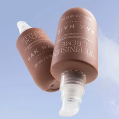 Brown styling polish serum bottle with white pump and wide cap, shown from below.