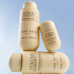 NAK Hair Volume Shampoo bottles set: large and travel-size, beige labels