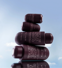 Stacked purple NAK Hair protein shampoo bottles, travel size 80 ml, side labels