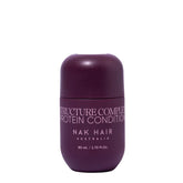 Travel-size hair conditioner bottle, dark purple, with flip-top cap.