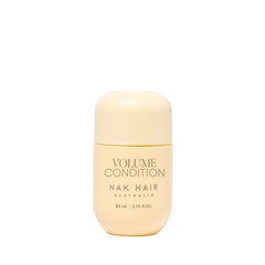 Travel-size hair conditioner bottle, pale beige, volume condition label, 80 ml.
