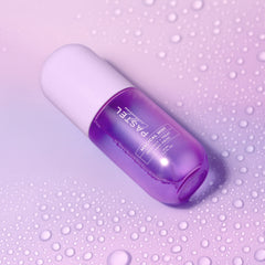 Angled close-up of purple hair mist bottle with clear spray nozzle and label.