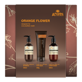 Orange flower hair care gift set with shampoo, hair mask, and conditioner bottles