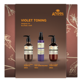Front of violet toning hair care set gift box with three bottles, including violet spray