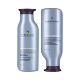 Hair care shampoo and conditioner bottles with metallic blue labels and dark caps