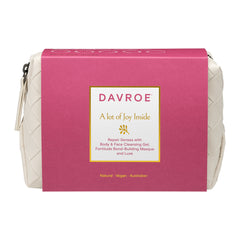Pink and cream quilted travel toiletry bag with front logo label and zipper closure