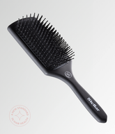 Black cushion hair brush with short rounded pins and ergonomic handle