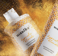 Hypnotic Blonde brightening shampoo and conditioner bottles with Wondher labels