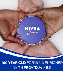 NIVEA Creme cream tin lid held in hands, blue top with NIVEA Creme logo