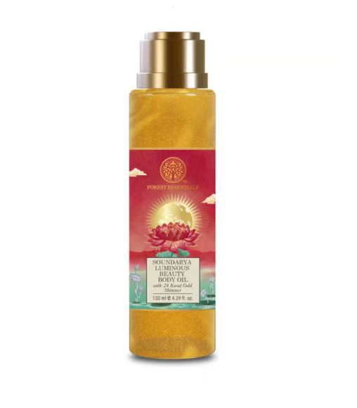 Gold body oil bottle with metallic cap and red label