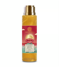 Gold body oil bottle with metallic cap and red label