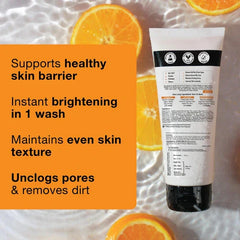 Vitamin C green tea face wash tube with back ingredient label, beside orange slices