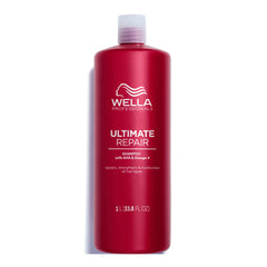 Ultimate Repair shampoo bottle, red cylinder with white pump cap, Wella Professionals branding.