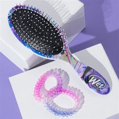 WetBrush paddle hair brush with pink spiral hair ties and purple handle