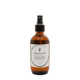 Yoga mat spray bottle, amber liquid with black pump and front label