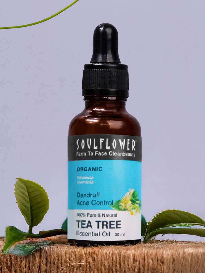 Amber tea tree essential oil bottle with black dropper and printed label