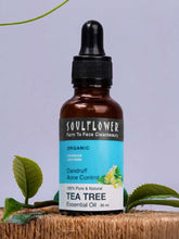 Amber tea tree essential oil bottle with black dropper and printed label