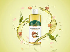 Argan oil hair oil bottle with argan leaves, fruit pieces, and droplets