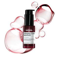 Hair gloss serum bottle with black pump, burgundy liquid, with pink glassy bubbles