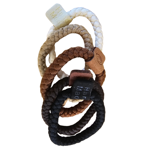 Handmade ponytail holder with braided fabric loops in dark brown, black, and light beige