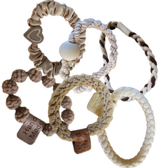 Handmade ponytail holder with braided fabric loops in beige, cream, and brown with tags
