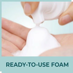 Foaming face wash being dispensed onto hands from a squeeze nozzle