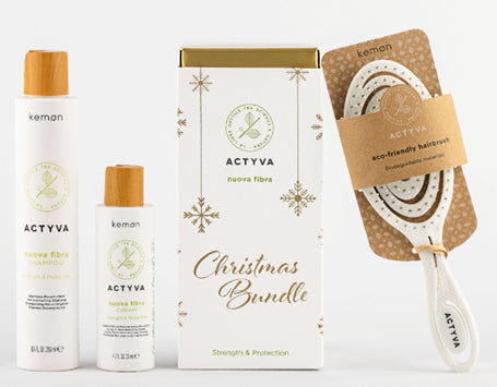 Hair care gift pack with shampoo bottle, second bottle, and kemon brush