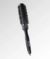 Round brush hair styling tool with black round barrel and heat bristles