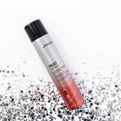 Heat Hero thermal protector spray bottle with scattered silver and black particles